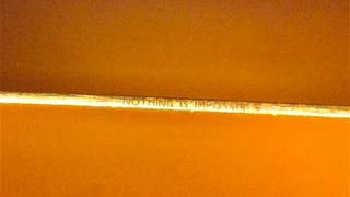 What It Takes to Engrave Words Onto the Edge of a Razor Blade
